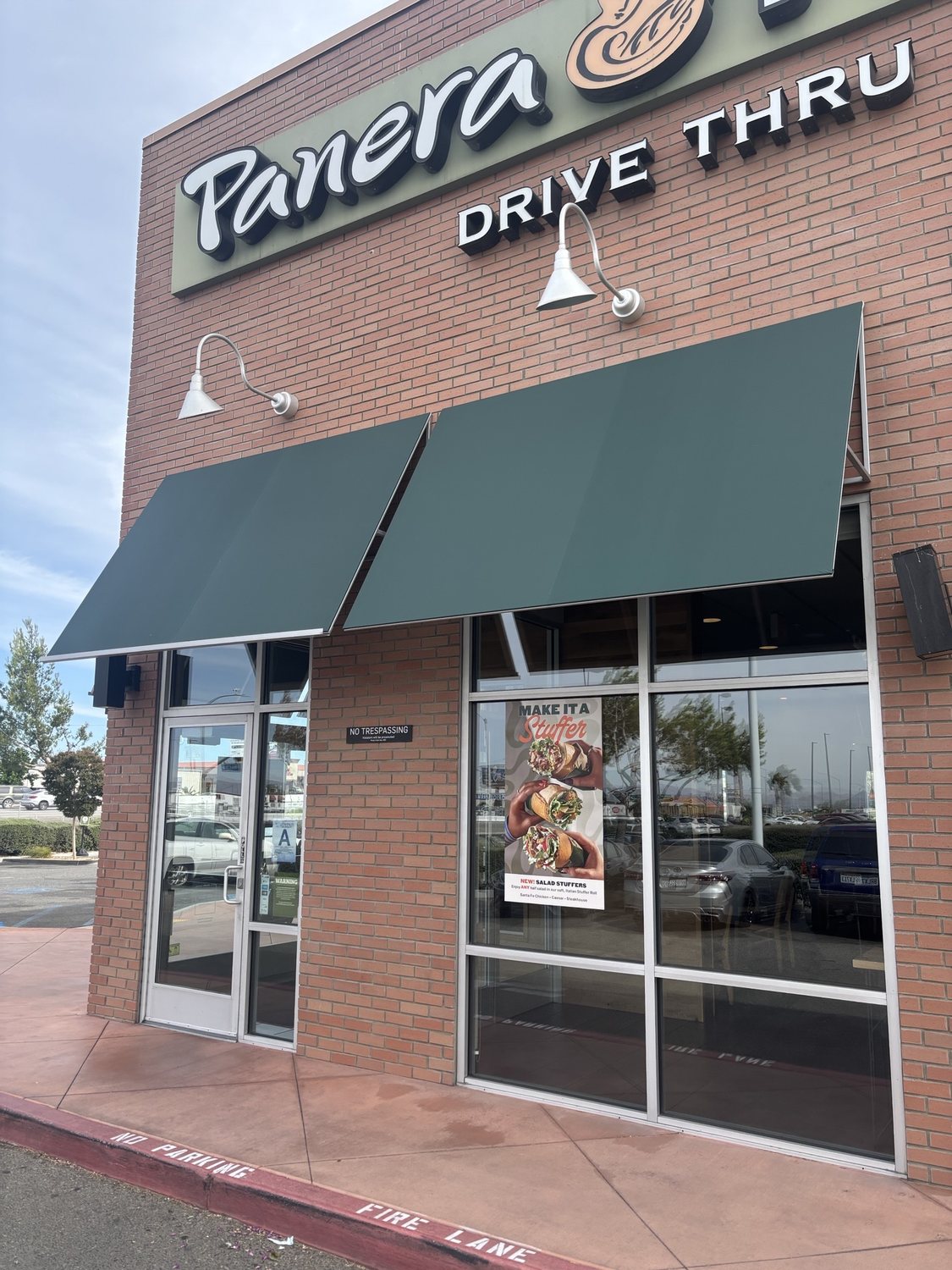 New solid green storefront awnings after replacement
