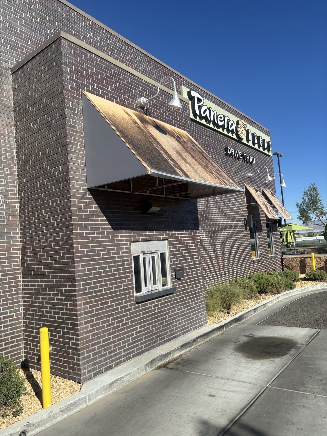 Sun-faded storefront awnings before replacement