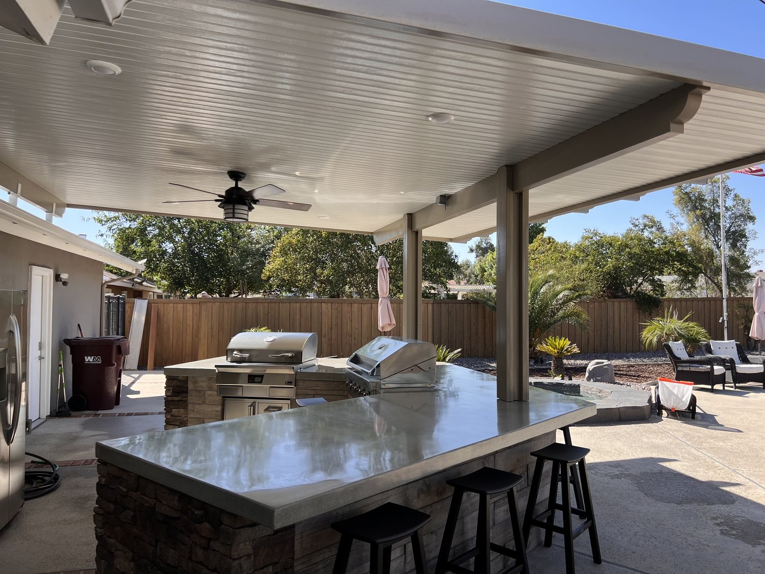 Custom patio cover over an outdoor kitchen and pool